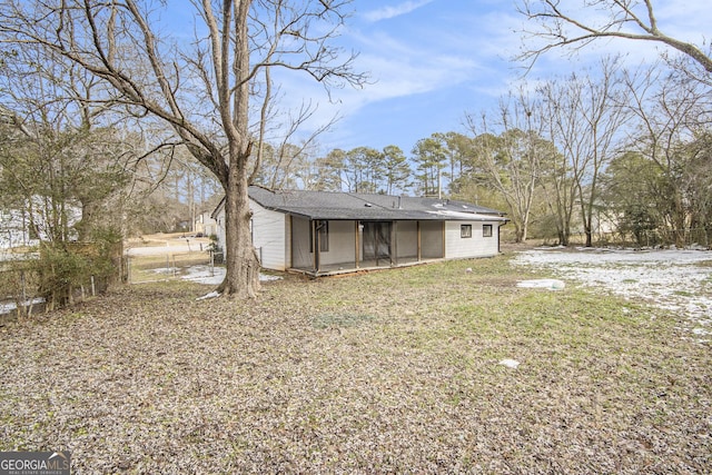 exterior space featuring a lawn and a sunroom