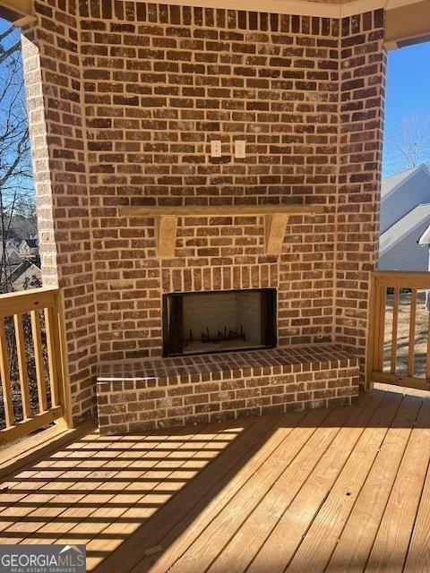 wooden deck with a fireplace