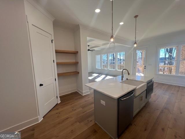 kitchen with stainless steel dishwasher, a kitchen island with sink, ceiling fan, pendant lighting, and white cabinetry