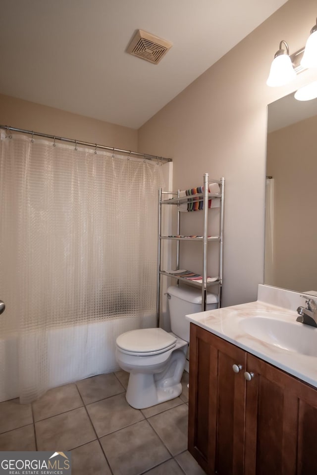 bathroom featuring vanity, toilet, and tile patterned flooring