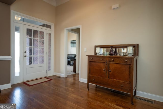 entryway with dark hardwood / wood-style flooring