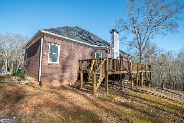 back of house featuring a wooden deck