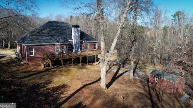 rear view of house featuring a wooden deck