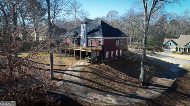 view of property exterior with a deck