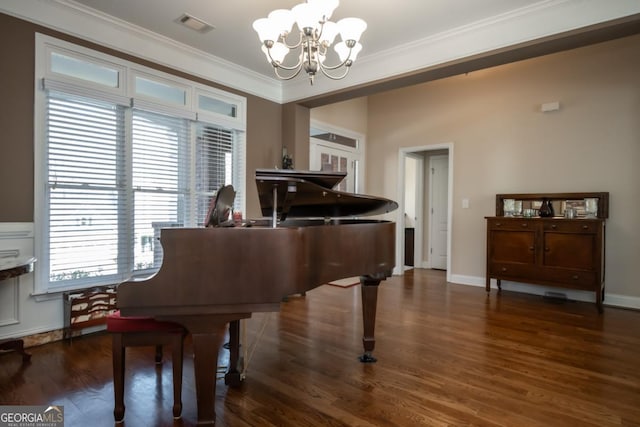 miscellaneous room featuring crown molding, dark hardwood / wood-style floors, and an inviting chandelier