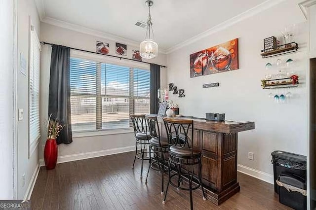 bar featuring dark brown cabinets, dark hardwood / wood-style flooring, and crown molding