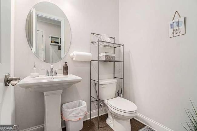 bathroom with hardwood / wood-style floors and toilet