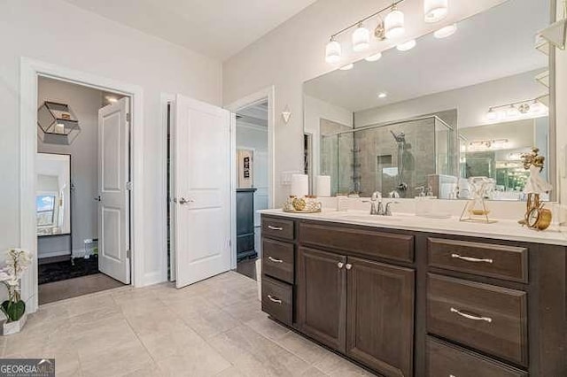 bathroom featuring vanity, tile patterned floors, and a shower with shower door