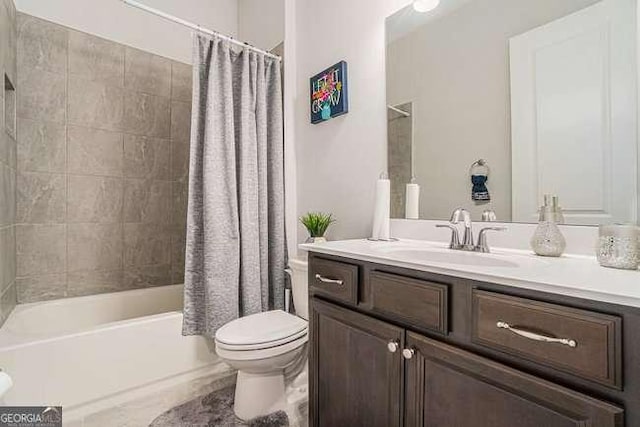 full bathroom featuring shower / tub combo, vanity, and toilet