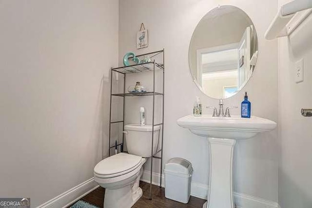 bathroom with wood-type flooring and toilet