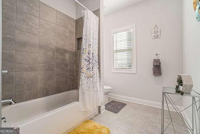 bathroom with tile patterned floors, toilet, and shower / tub combo