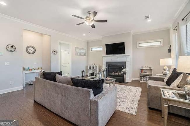 living room with dark hardwood / wood-style flooring, ceiling fan, and ornamental molding