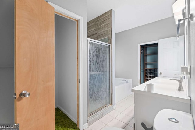 bathroom featuring tile patterned flooring, vanity, and shower with separate bathtub