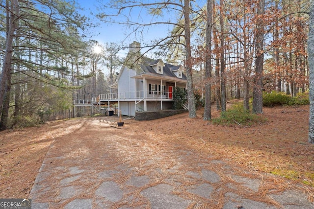 cape cod house featuring a porch