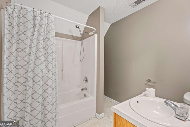 bathroom featuring vanity, a textured ceiling, and shower / tub combo