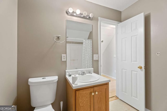 bathroom featuring vanity, a shower with shower curtain, tile patterned flooring, toilet, and a textured ceiling