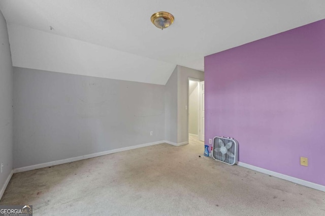 bonus room with light carpet and lofted ceiling