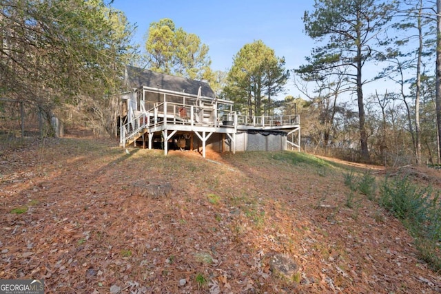 rear view of house featuring a wooden deck