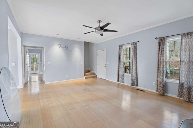 empty room featuring ceiling fan, light wood-type flooring, and ornamental molding