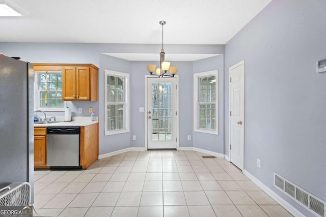 kitchen with stainless steel dishwasher, a notable chandelier, fridge, decorative light fixtures, and light tile patterned floors