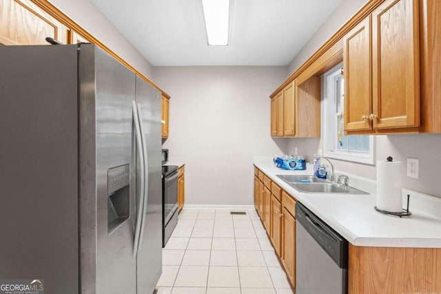 kitchen with light tile patterned floors, sink, and appliances with stainless steel finishes