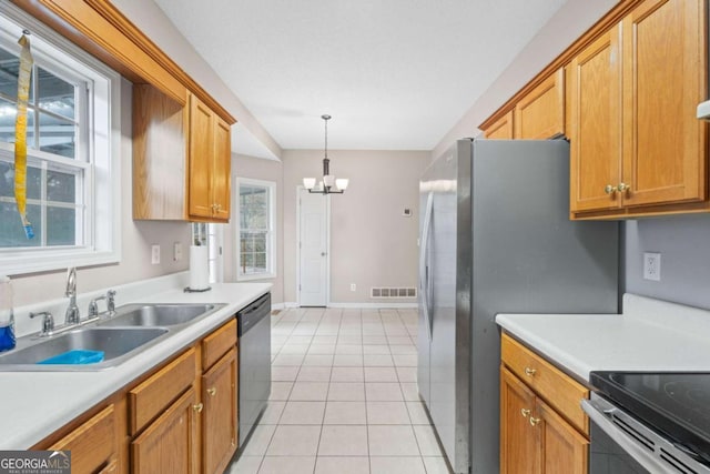 kitchen with sink, dishwasher, a notable chandelier, decorative light fixtures, and light tile patterned floors