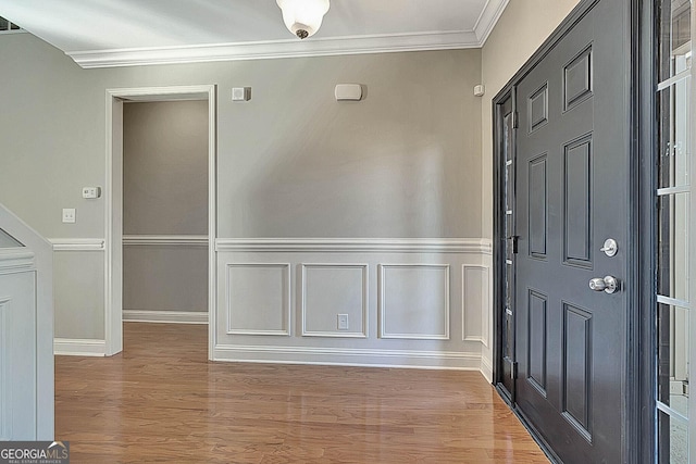 foyer entrance featuring hardwood / wood-style floors and ornamental molding