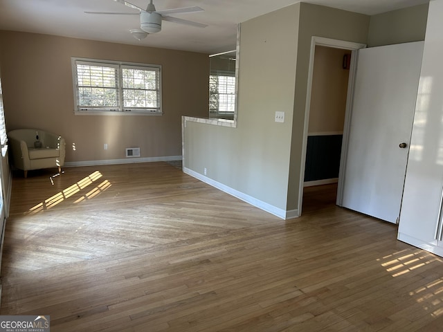 empty room with hardwood / wood-style flooring and ceiling fan