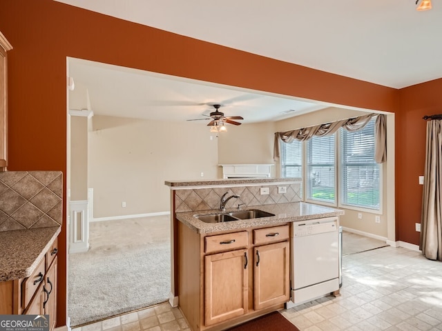 kitchen featuring decorative backsplash, light carpet, white dishwasher, ceiling fan, and sink