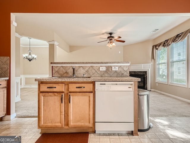 kitchen with white dishwasher, tasteful backsplash, light colored carpet, and sink