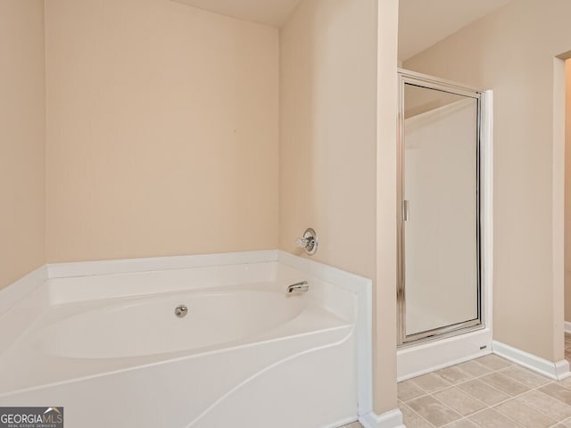 bathroom featuring tile patterned floors and independent shower and bath