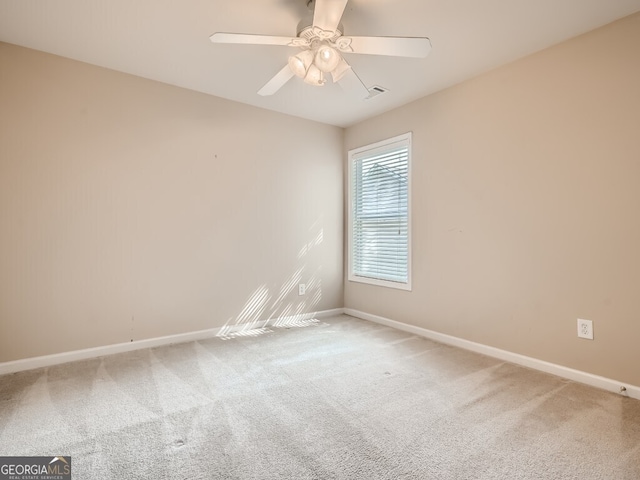 spare room with carpet flooring and ceiling fan