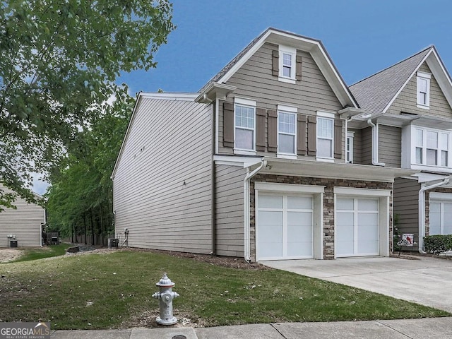 view of front of house with a garage and a front lawn