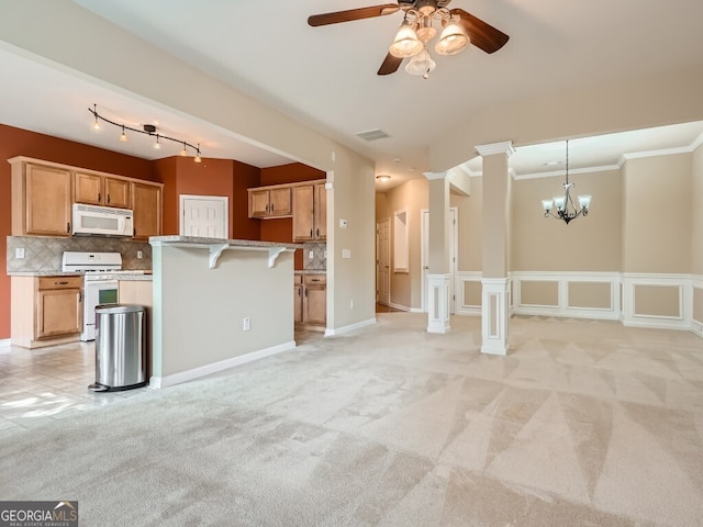 kitchen featuring a kitchen bar, tasteful backsplash, ornamental molding, white appliances, and light colored carpet