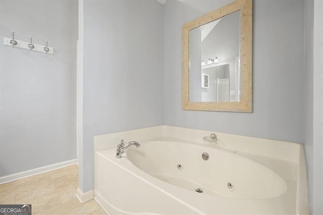 bathroom with a tub to relax in and tile patterned flooring