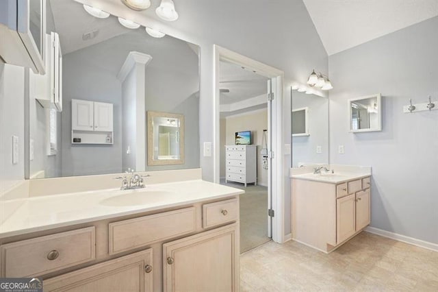 bathroom with vanity and vaulted ceiling