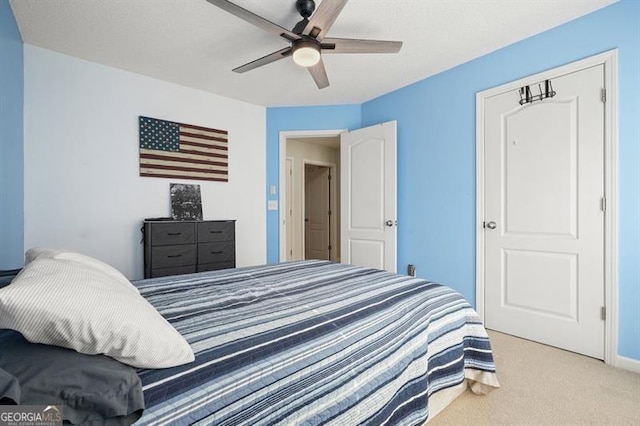 bedroom with light carpet and ceiling fan