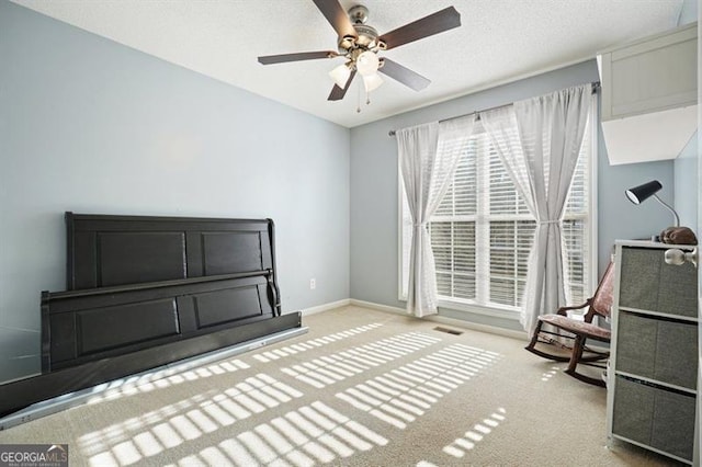 miscellaneous room featuring a textured ceiling, ceiling fan, and light carpet