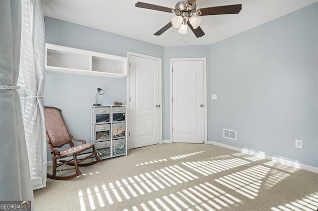 sitting room with carpet flooring and ceiling fan