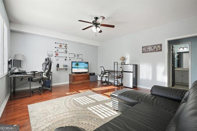 living room with a wealth of natural light, ceiling fan, and hardwood / wood-style floors