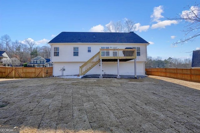 rear view of property featuring a wooden deck