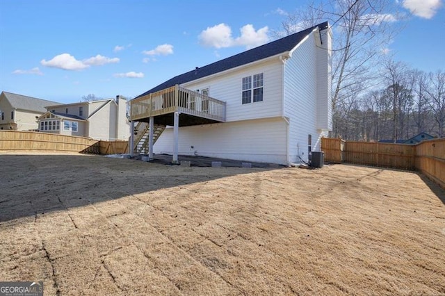 rear view of house featuring cooling unit and a wooden deck