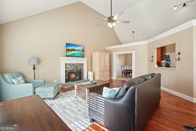 living room with ceiling fan, dark hardwood / wood-style flooring, a fireplace, and high vaulted ceiling