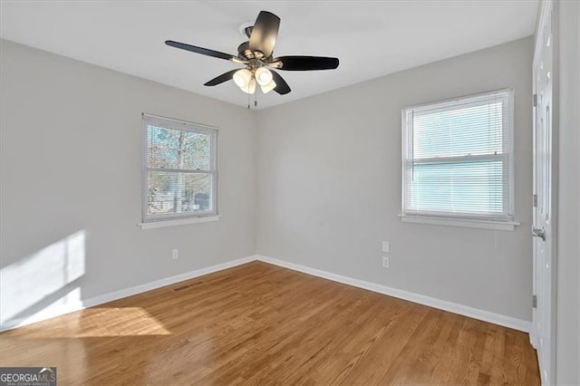 unfurnished room featuring ceiling fan and hardwood / wood-style flooring