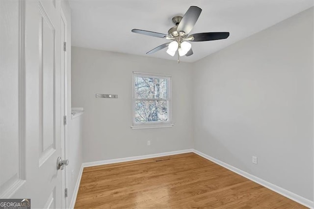 empty room featuring light wood-type flooring and ceiling fan