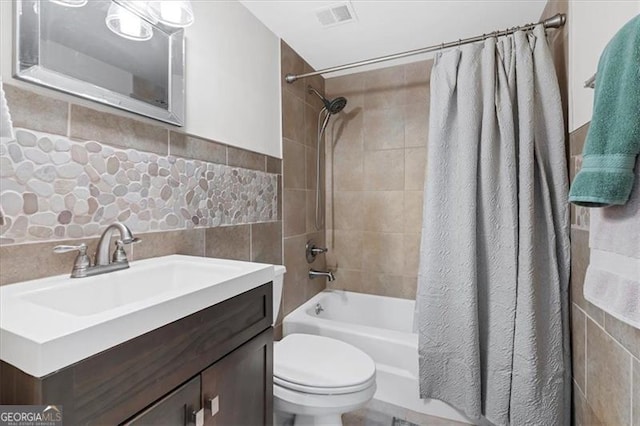 full bathroom featuring shower / tub combo, vanity, tile walls, and toilet