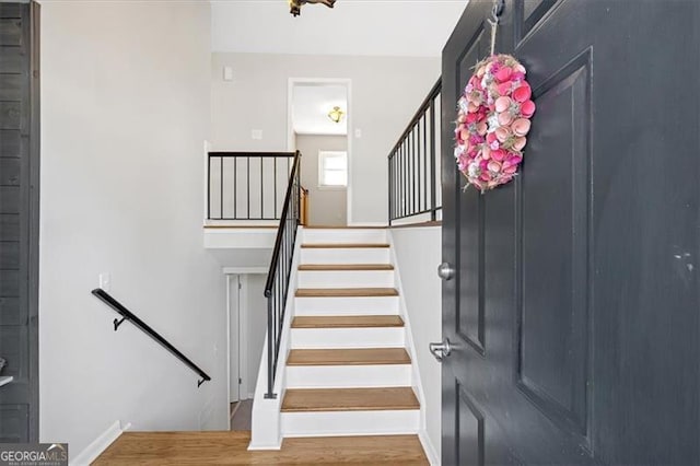 staircase with hardwood / wood-style flooring