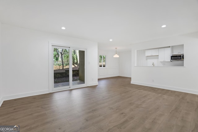 unfurnished living room with hardwood / wood-style floors