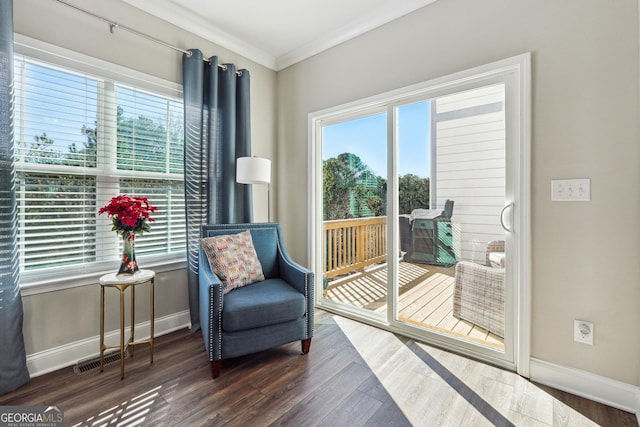 living area with dark hardwood / wood-style flooring and crown molding