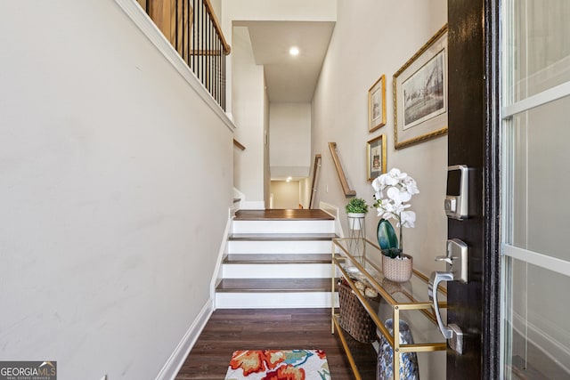 stairs featuring hardwood / wood-style floors